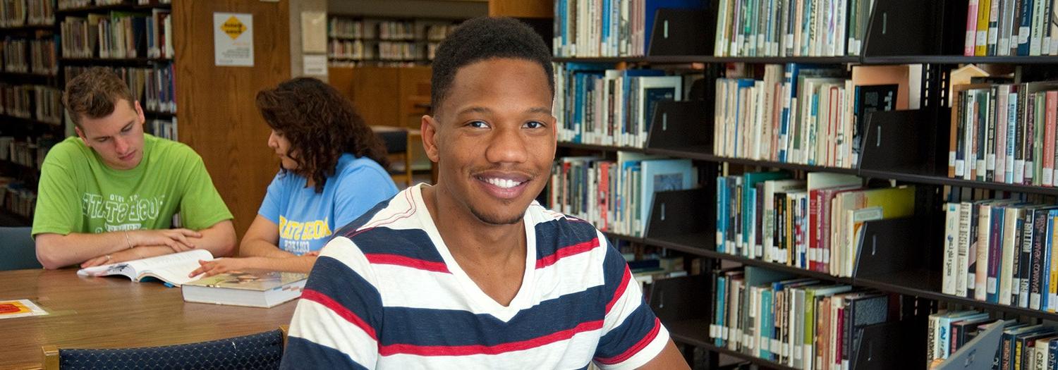 Student standing in the Library